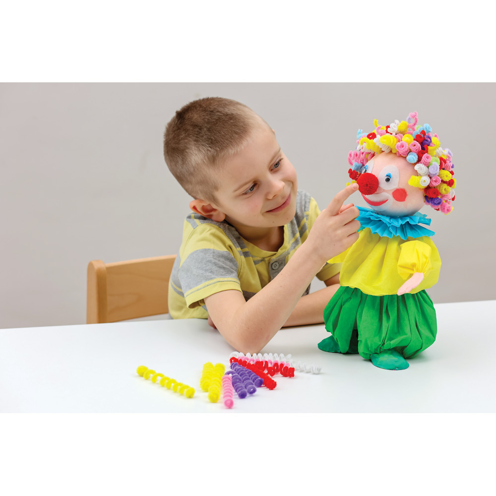 Chlapec si hraje s barevným klaunem ozdobeným kadeřemi z kreativních drátků.